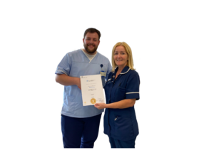 Matt Coles is pictured with Lorraine Conway, Treatment Room Sister, receiving his Nursing Associate certificate.